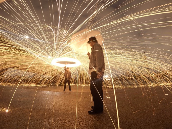 Long shot of person making circles with light